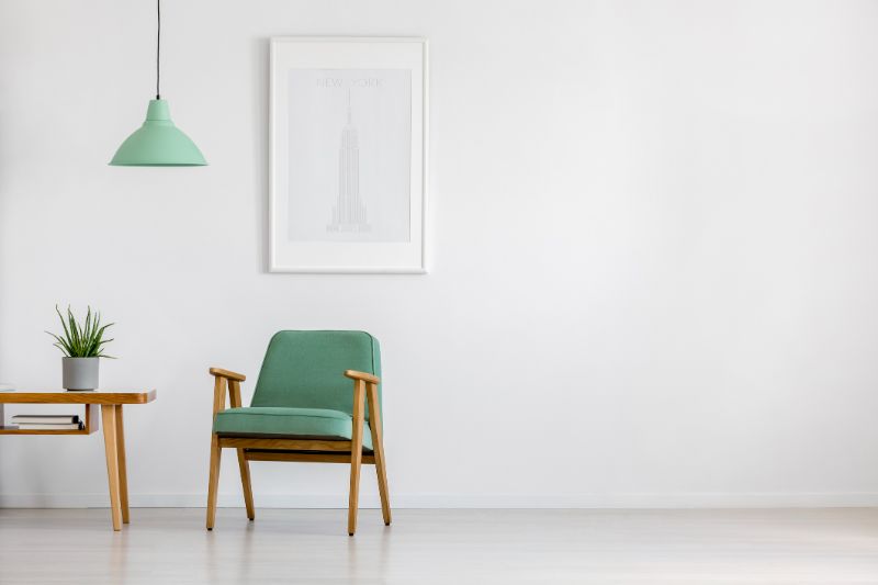 Green retro armchair and white walls minimal interior