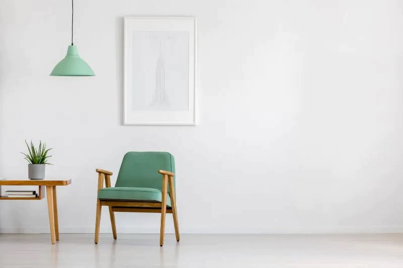 Green retro armchair and white walls minimal interior