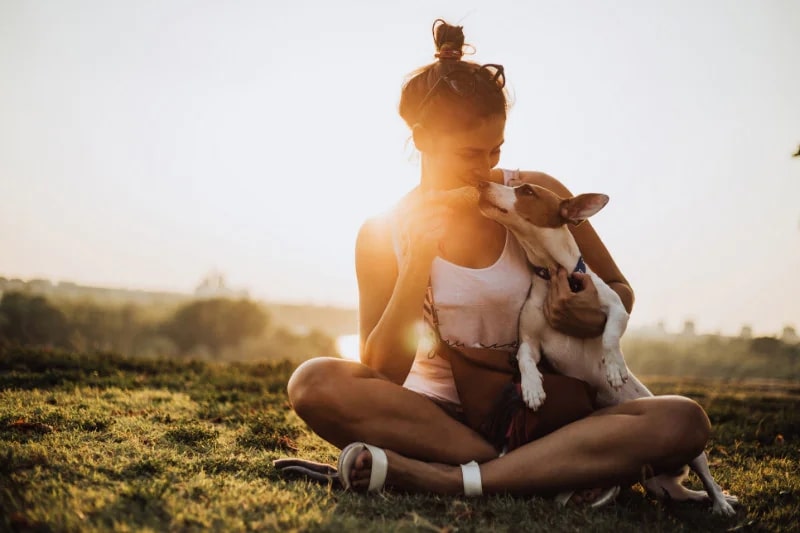 A woman with her dog, eating ice cream