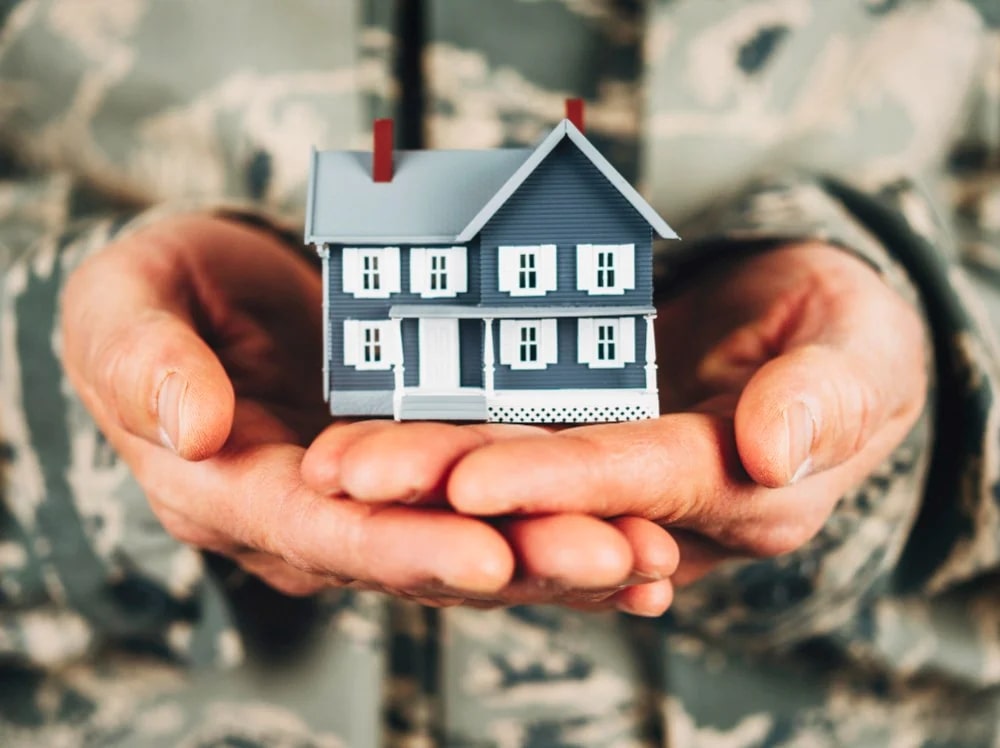 Holding a mini house model