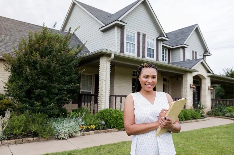 Home inspector in front of a house to be inspected