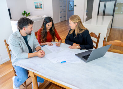 Real Estate or Insurance agent or lawyer with couple signing home loan mortgage or contract documents