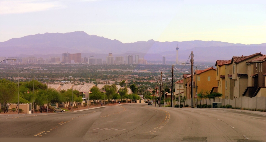 Street from a North Las Vegas neighborhood, with the skyline of the city and mountains in the background