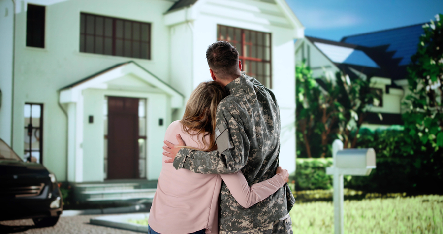 Veteran real estate agent Hands Keys To Happy Young Couple Buying House